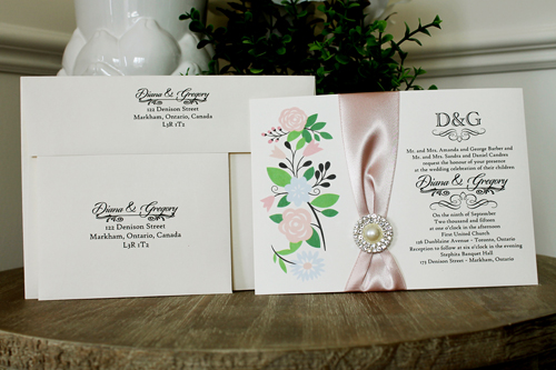 Invitation 1346: Cream Smooth, Deep Blush Ribbon, Brooch/Buckle G - Cut floral print on the cream card with a deep blush ribbon and pearl brooch